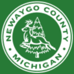 White circle with green lettering, deer jumping in front of a pine tree. Green background.