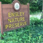 Wooden Sign for Ensley Nature Preserve in greenery.